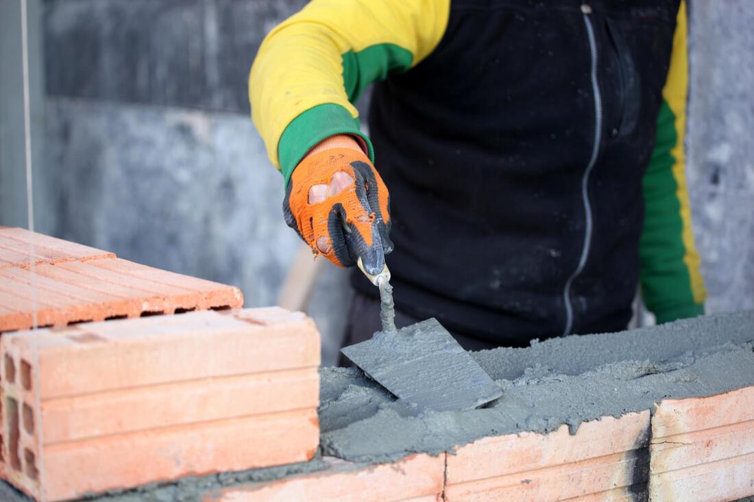 man installing brick walls